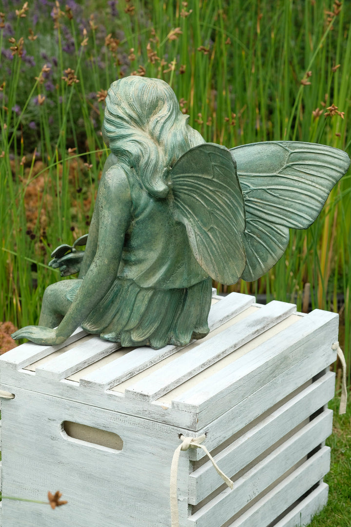 Bronze sculpture of a winged fairy with a butterfly - green patina