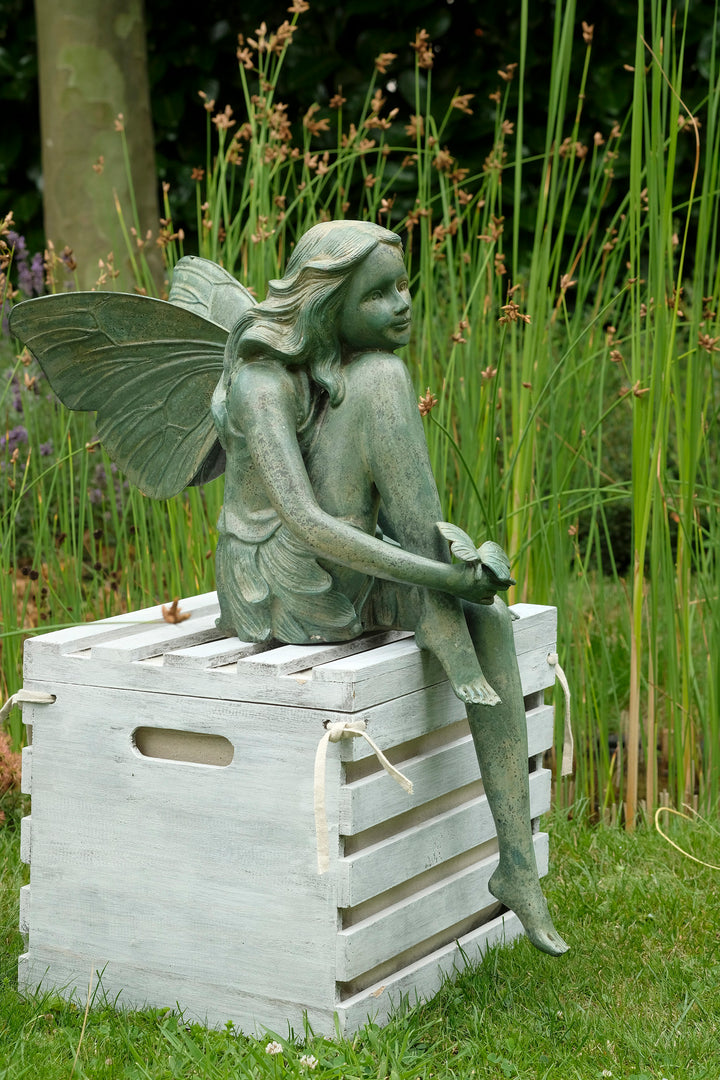 Bronze sculpture of a winged fairy with a butterfly - green patina