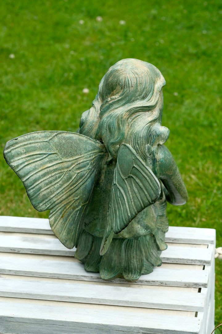 Bronze sculpture of a winged fairy with a butterfly - green patina