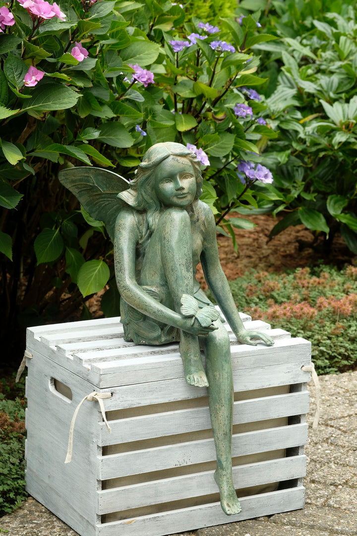 Bronze sculpture of a winged fairy with a butterfly - green patina