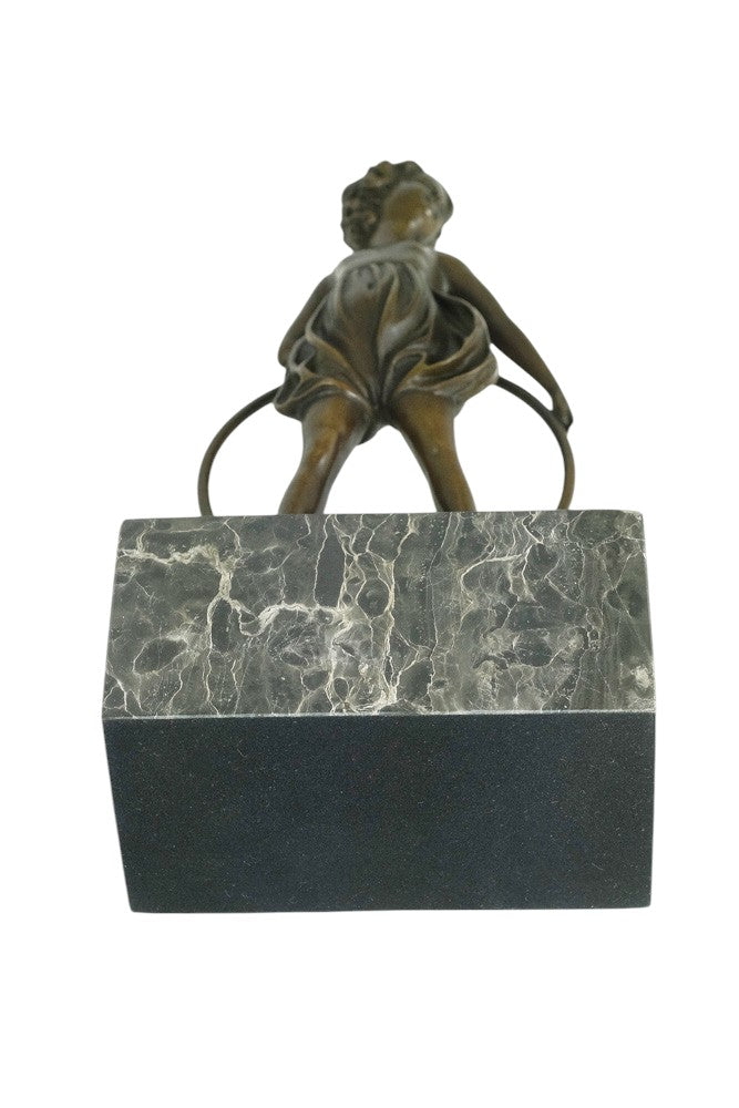 Bronze sculpture of a little girl with a hoop
