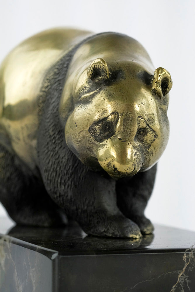 Bronze sculpture of a walking panda bear