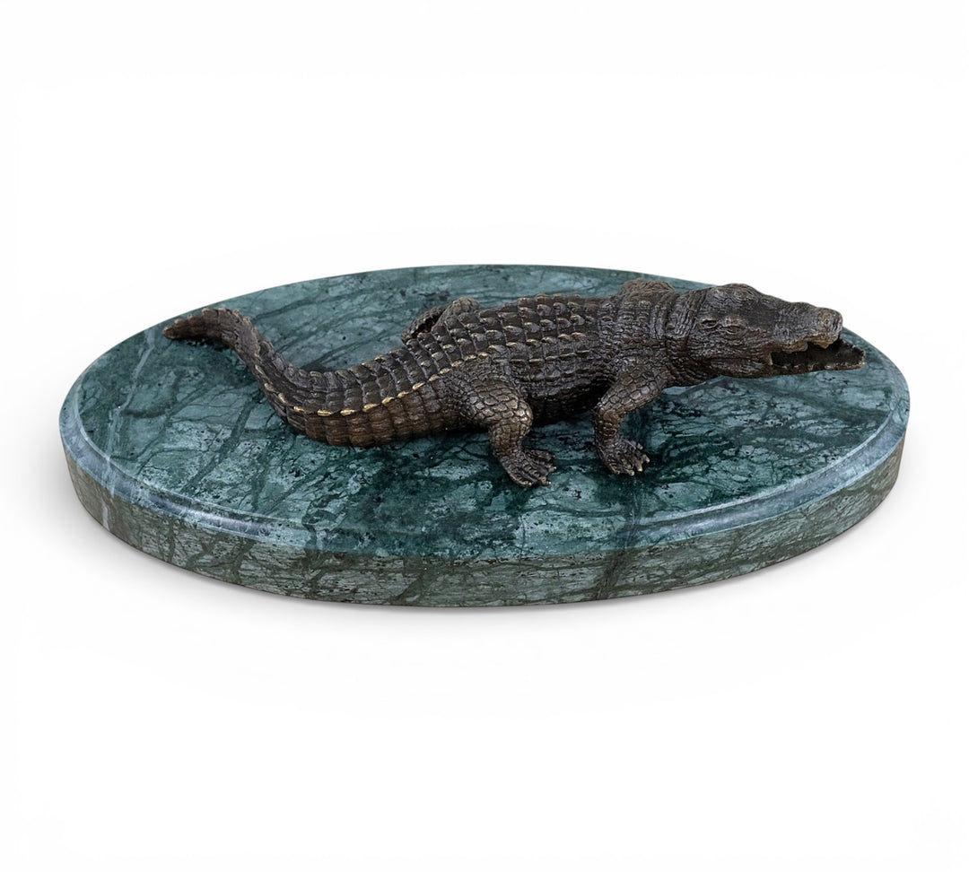 Bronze crocodile sculpture on green marble base