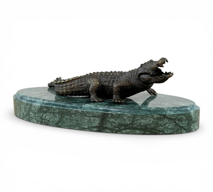 Bronze crocodile sculpture on green marble base
