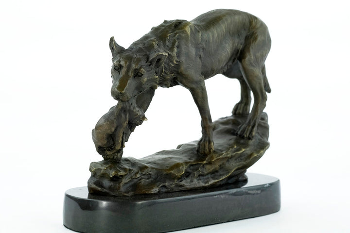 Bronze sculpture of a wolf carrying her young
