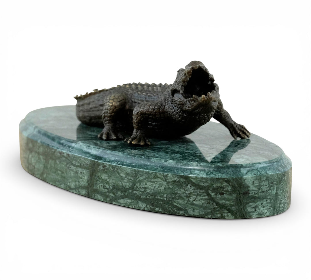 Bronze crocodile sculpture on green marble base