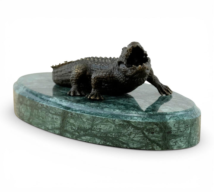 Bronze crocodile sculpture on green marble base