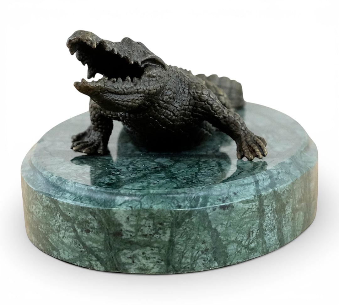 Bronze crocodile sculpture on green marble base