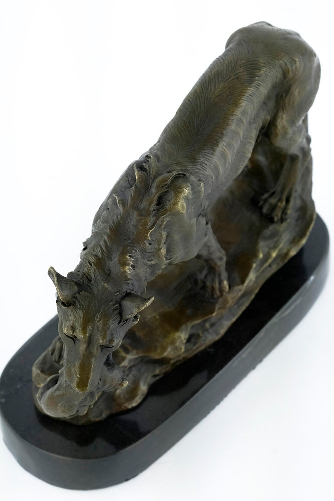 Bronze sculpture of a wolf carrying her young