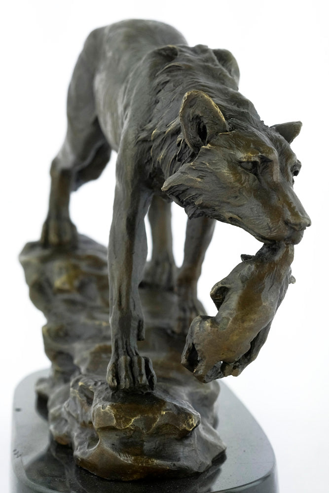 Bronze sculpture of a wolf carrying her young