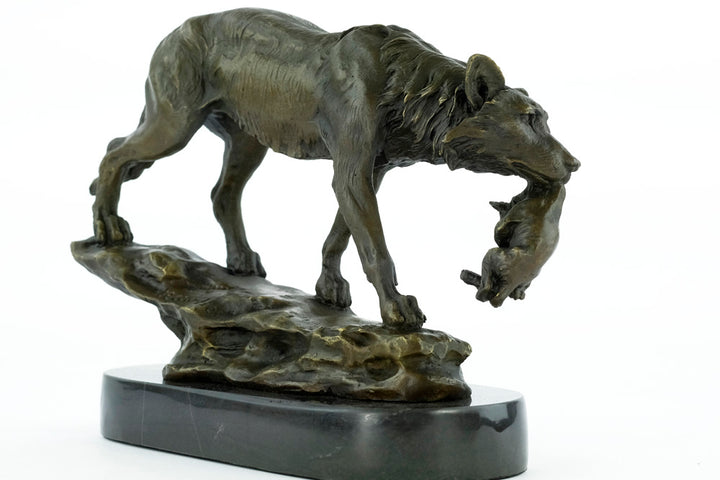 Bronze sculpture of a wolf carrying her young