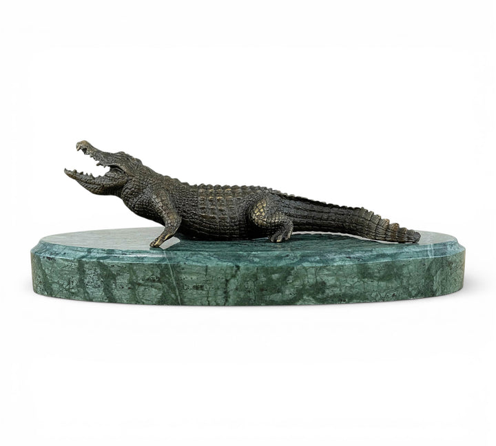 Bronze crocodile sculpture on green marble base