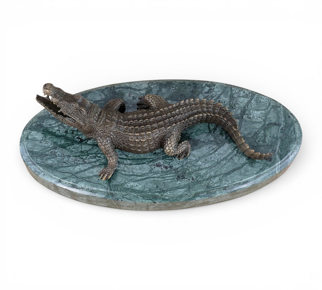 Bronze crocodile sculpture on green marble base