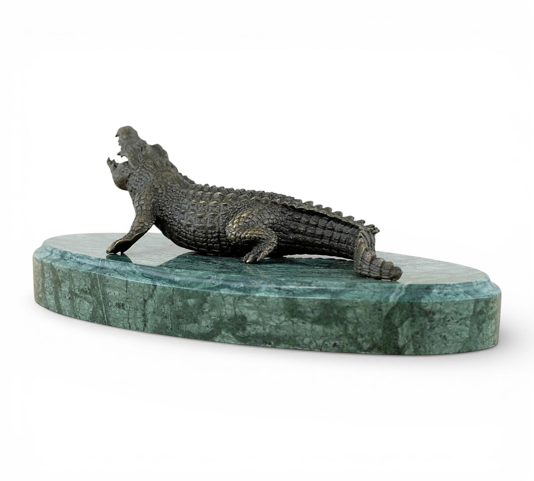 Bronze crocodile sculpture on green marble base