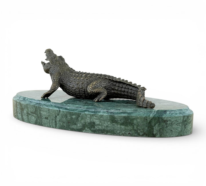 Bronze crocodile sculpture on green marble base