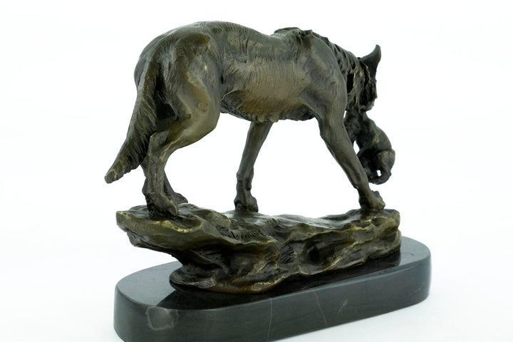 Bronze sculpture of a wolf carrying her young