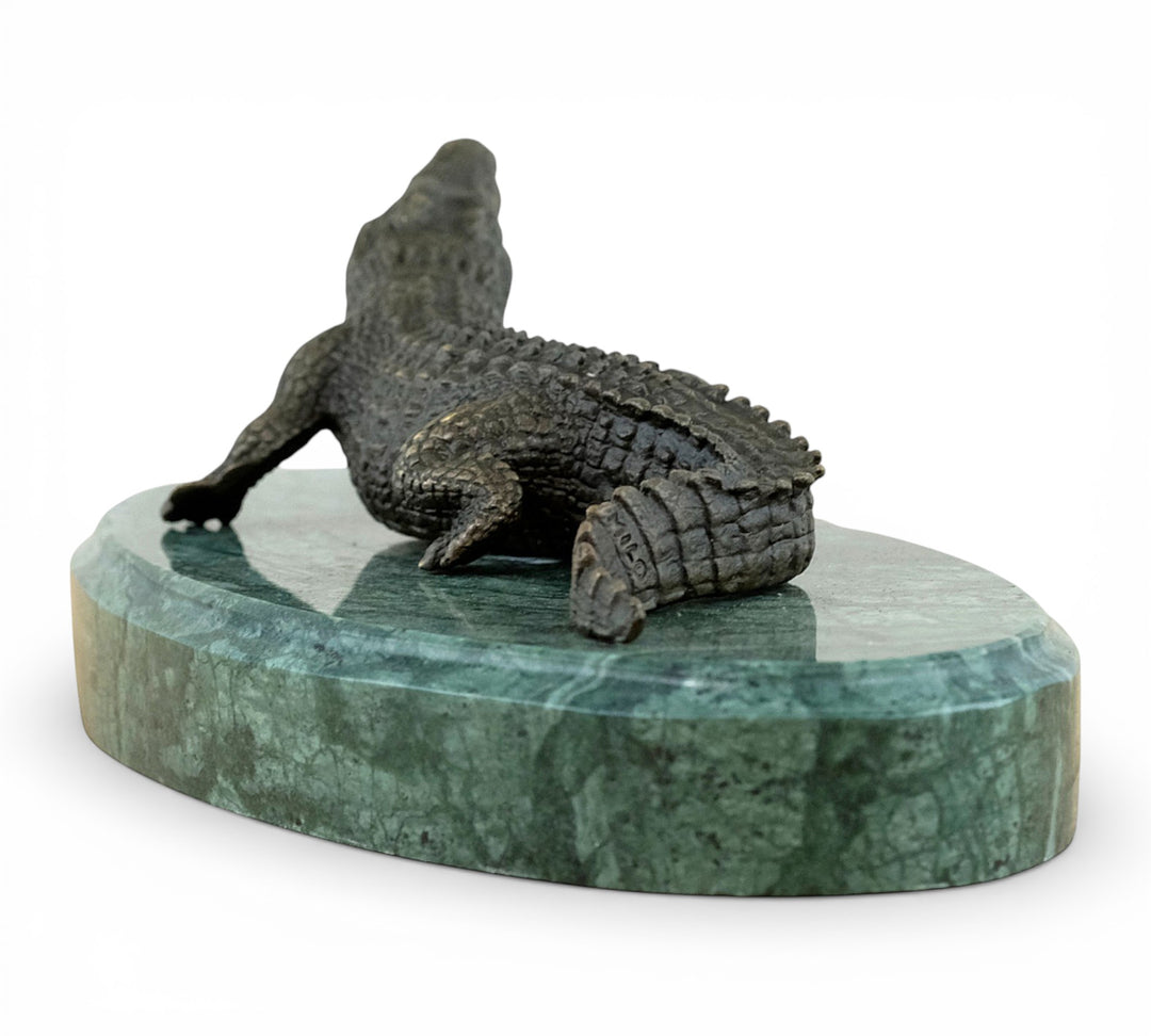 Bronze crocodile sculpture on green marble base