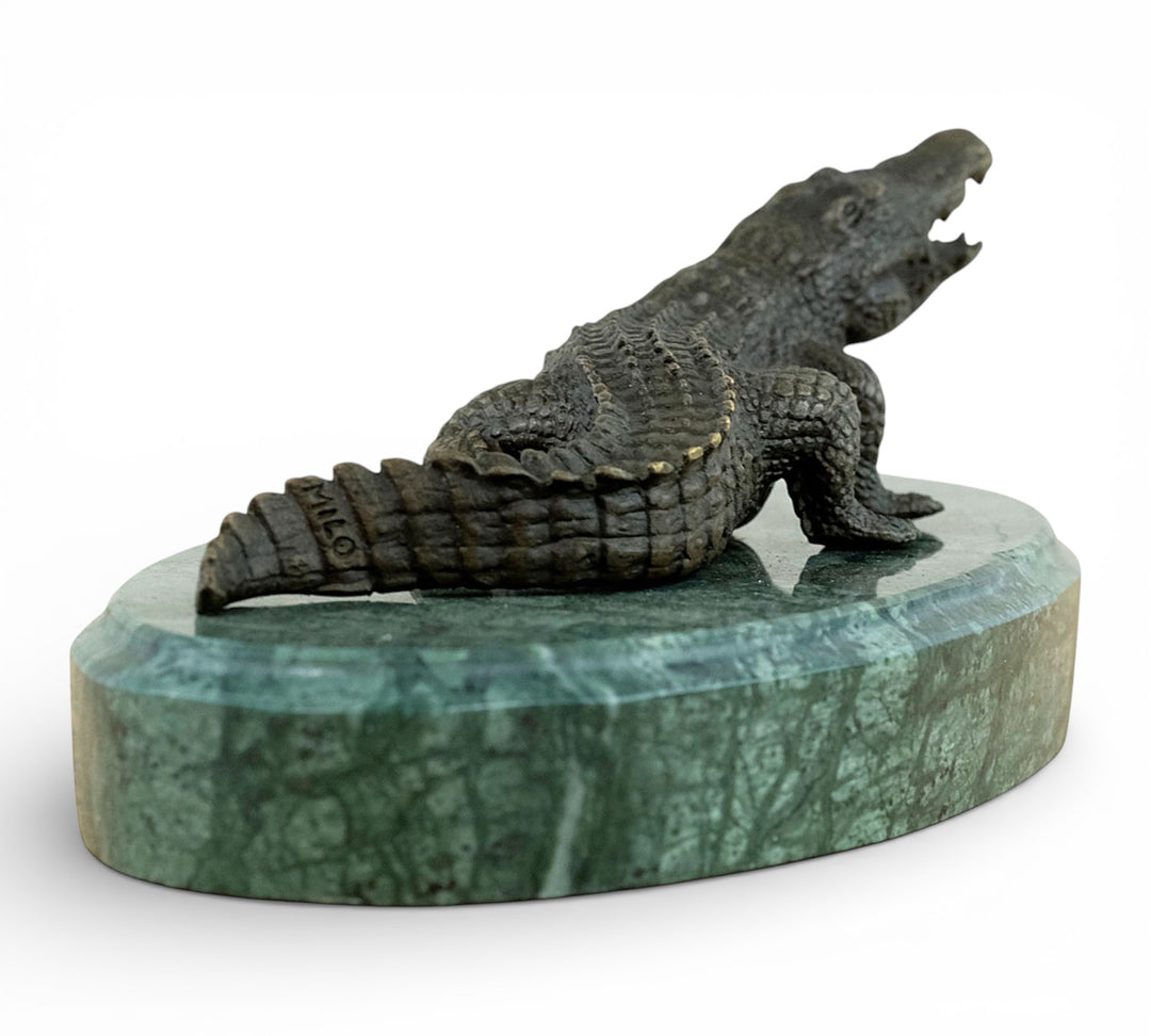 Bronze crocodile sculpture on green marble base
