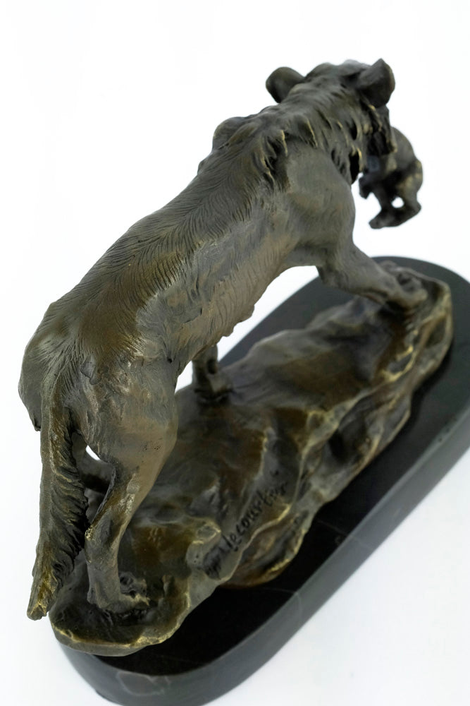 Bronze sculpture of a wolf carrying her young