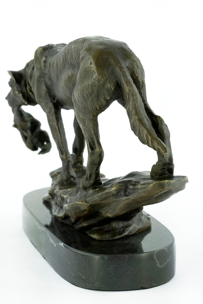Bronze sculpture of a wolf carrying her young