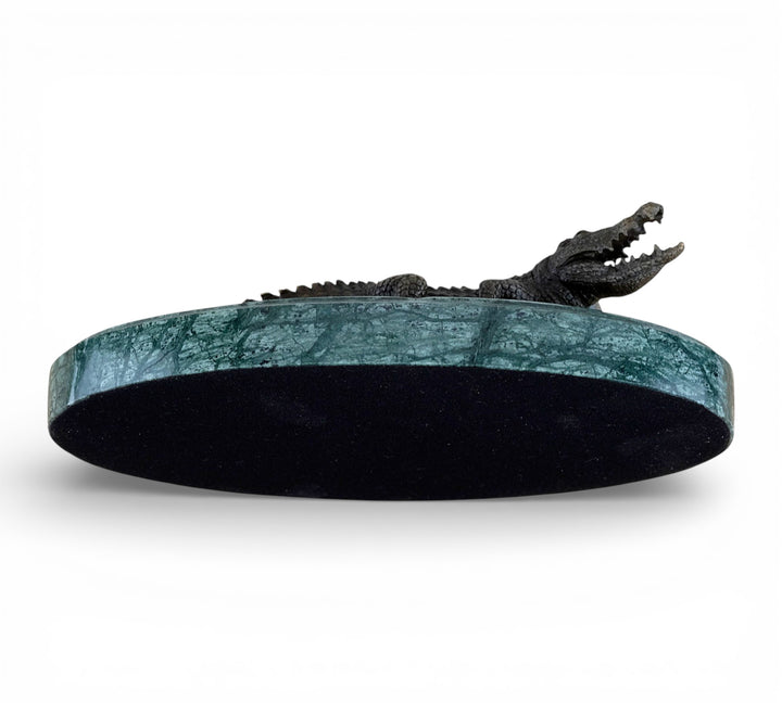 Bronze crocodile sculpture on green marble base