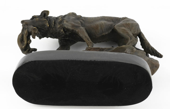 Bronze sculpture of a wolf carrying her young