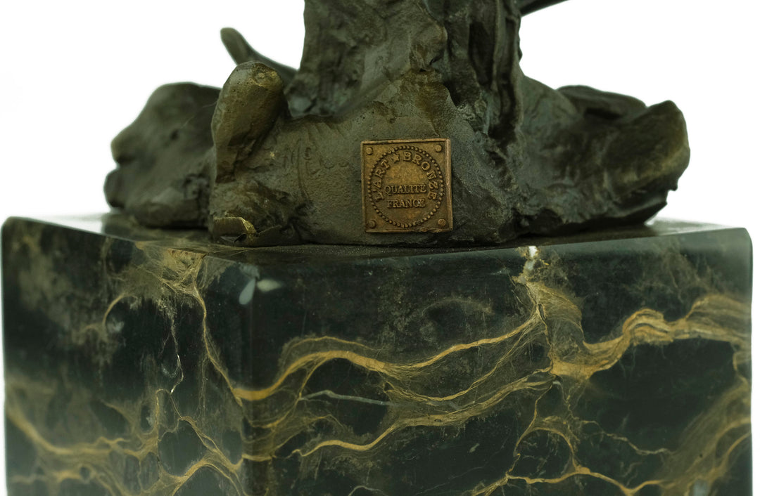 Bronze sculpture of a warbler bird sitting on a branch