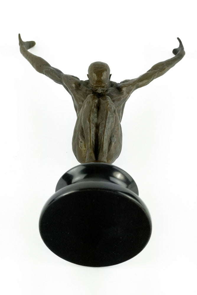Bronze sculpture of a male with outstretched arms
