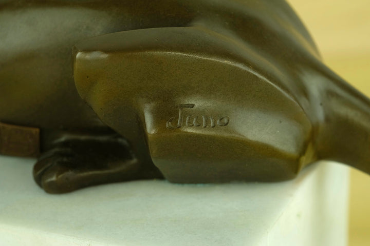 Bronze sculpture of a cubist style panther lying on a white marble base
