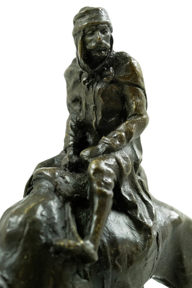Bronze sculpture of a camel with bedouin rider