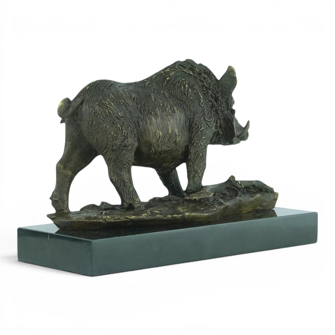 Bronze sculpture of a wild boar on a marble plateau