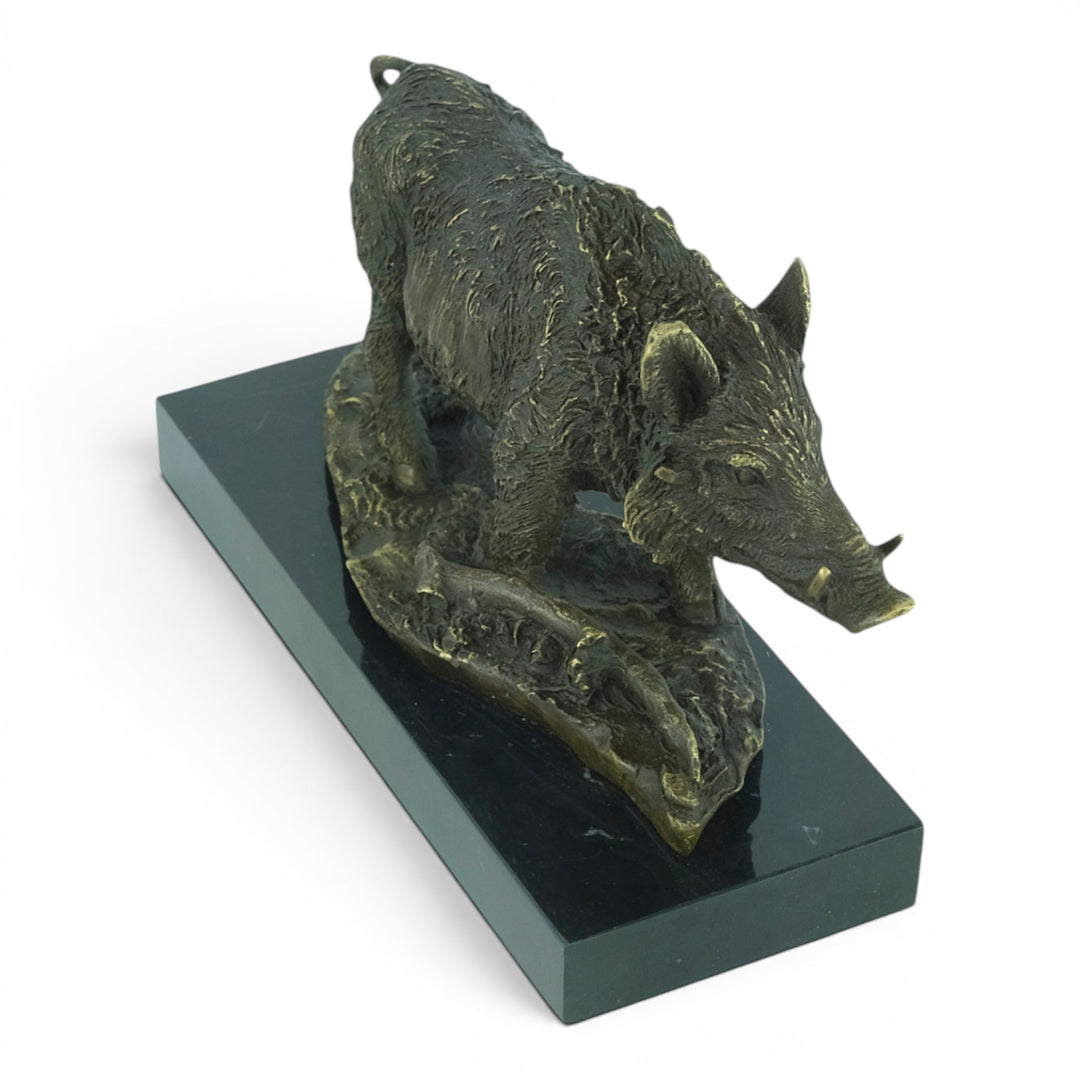 Bronze sculpture of a wild boar on a marble plateau