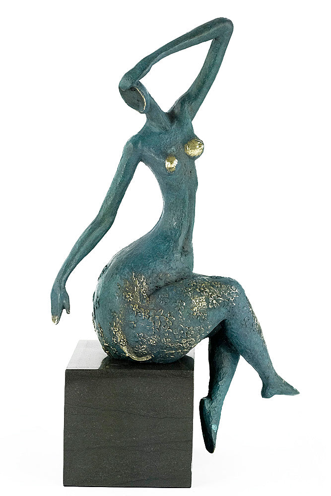 Modern bronze sculpture of a female sitting in a graceful pose