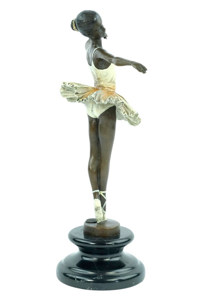 Bronze sculpture of a ballerina standing tip-toe wearing a white tutu