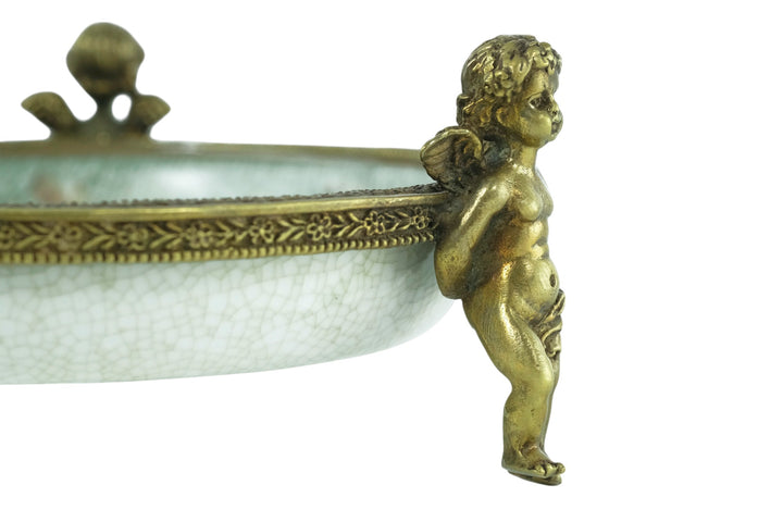 Porcelain bowl carried by three bronze cherubs
