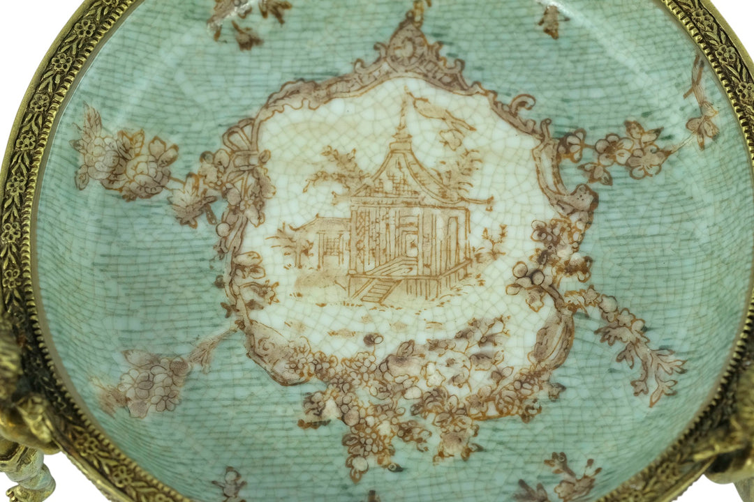 Porcelain bowl carried by three bronze cherubs