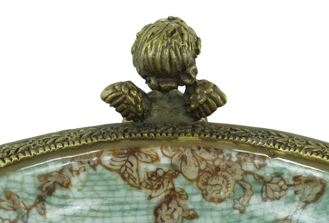 Porcelain bowl carried by three bronze cherubs