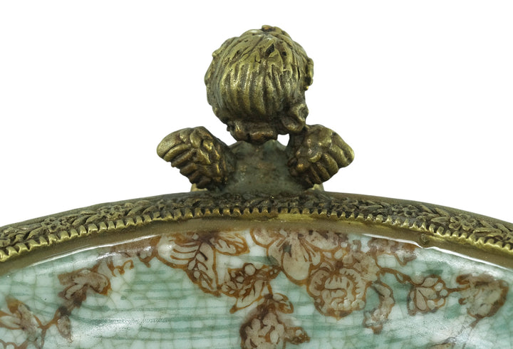 Porcelain bowl carried by three bronze cherubs