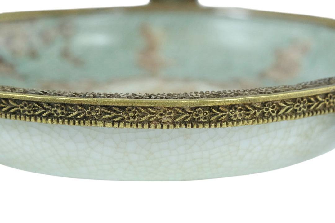 Porcelain bowl carried by three bronze cherubs