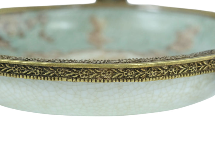 Porcelain bowl carried by three bronze cherubs