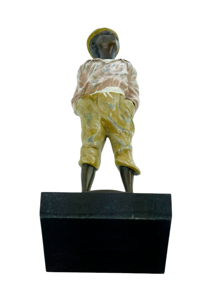 Bronze sculpture of a young street boy whistling