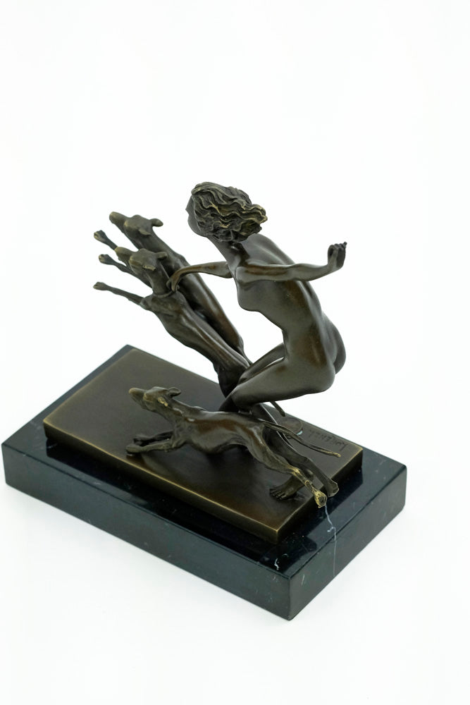 Bronze sculpture of a female running with three dogs