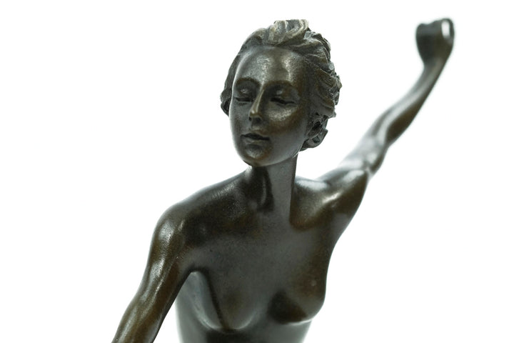 Bronze sculpture of a female running with three dogs