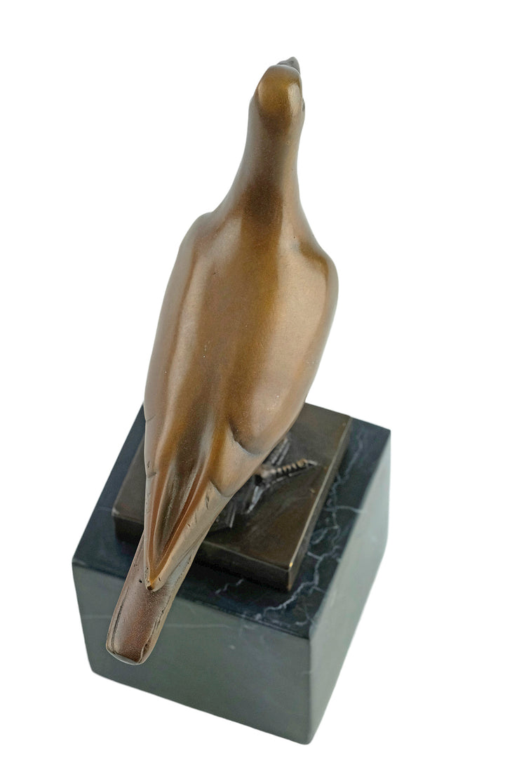 Bronze sculpture of a standing pigeon