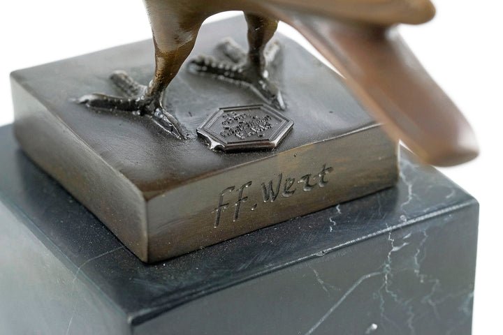 Bronze sculpture of a standing pigeon