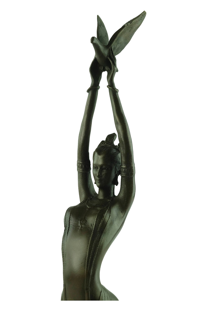 Modern bronze sculpture of a female releasing a bird
