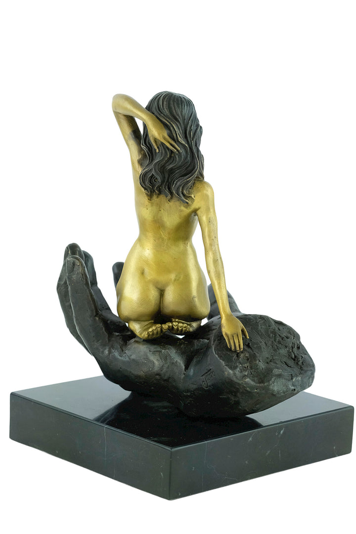 Modern bronze sculpture of a female sitting in a hand