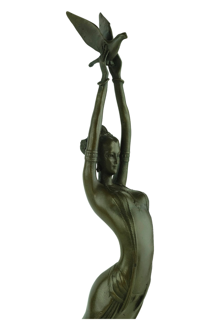 Modern bronze sculpture of a female releasing a bird