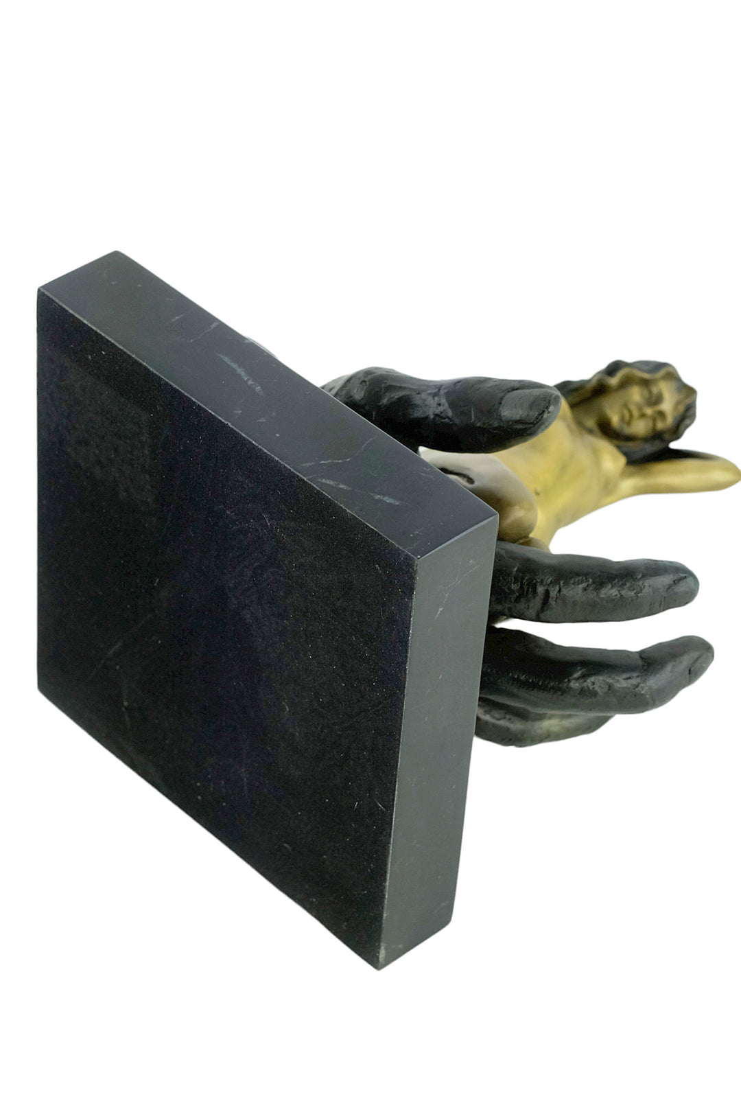 Modern bronze sculpture of a female sitting in a hand