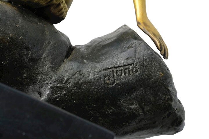 Modern bronze sculpture of a female sitting in a hand